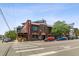 A street view of a brick building, with a restaurant signage, landscaping, and cars parked along the street at 2508 Kensing Ct, Denver, CO 80211