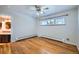 Hardwood floor bedroom with an ensuite bathroom and large window at 5253 Hale Pkwy, Denver, CO 80220