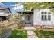 Inviting covered front porch with stone accents and manicured lawn, perfect for relaxing outdoors at 2552 Stonewall Ln, Lafayette, CO 80026