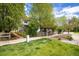 Charming home with a well-kept lawn, mature trees, and a 'For Sale' sign, inviting potential buyers at 2552 Stonewall Ln, Lafayette, CO 80026