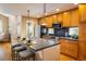 Well-lit kitchen featuring wood cabinets, stainless appliances, and an island with barstool seating at 2552 Stonewall Ln, Lafayette, CO 80026