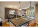 Spacious kitchen featuring an island with bar seating, open to the dining and living areas at 2552 Stonewall Ln, Lafayette, CO 80026