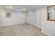 The finished basement offers a window, closet, and neutral carpet throughout at 10966 W Half Moon Pass, Littleton, CO 80127