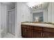 This bathroom offers dual sinks with mosaic tile accents and a glass enclosed shower at 10966 W Half Moon Pass, Littleton, CO 80127