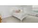 This cozy bedroom provides neutral walls, carpet, a window, and a decorative iron bed frame at 10966 W Half Moon Pass, Littleton, CO 80127