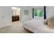 This bedroom has neutral tones, a window with nice views, and access to an ensuite bathroom at 10966 W Half Moon Pass, Littleton, CO 80127