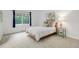This bright bedroom offers a neutral palette, a large window, and plush carpeting at 10966 W Half Moon Pass, Littleton, CO 80127