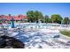Spacious community pool area with numerous lounge chairs and umbrellas, perfect for summer relaxation and socializing at 10966 W Half Moon Pass, Littleton, CO 80127