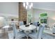 Open-concept dining room with views of the living room and fireplace at 10966 W Half Moon Pass, Littleton, CO 80127
