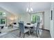 Bright dining room with a modern chandelier and views of the yard at 10966 W Half Moon Pass, Littleton, CO 80127