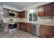 Updated kitchen with stainless steel appliances and modern cabinetry at 10966 W Half Moon Pass, Littleton, CO 80127