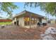 Backyard with a stone patio, outdoor seating area, garden beds, and a modern home design at 5405 S Lowell Blvd, Littleton, CO 80123