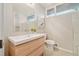 Modern bathroom with a light wood vanity, white countertop, a window, and gray walls at 5405 S Lowell Blvd, Littleton, CO 80123
