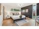 Stylish bedroom featuring a large bed, modern lighting, and a dark accent wall at 5405 S Lowell Blvd, Littleton, CO 80123