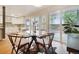 Bright dining area with a glass table, modern chairs, and views of the kitchen and fenced-in backyard at 5405 S Lowell Blvd, Littleton, CO 80123