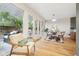 Charming dining area with patio access, hardwood floors, bright lighting, and an adjacent living space at 5405 S Lowell Blvd, Littleton, CO 80123