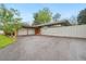 Mid-century modern home featuring an attached two-car garage and mature trees at 5405 S Lowell Blvd, Littleton, CO 80123