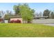 Well-maintained front lawn and mature trees accenting the home's facade at 5405 S Lowell Blvd, Littleton, CO 80123