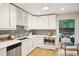 Bright kitchen showcasing white cabinetry, stainless steel appliances, and views to outdoor seating at 5405 S Lowell Blvd, Littleton, CO 80123