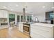 Bright kitchen featuring stainless steel appliances, white cabinetry, and hardwood floors with natural light at 5405 S Lowell Blvd, Littleton, CO 80123