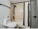 Cozy bathroom featuring a shower-tub combination with neutral tiling and black fixtures at 4671 S Decatur St # 232, Englewood, CO 80110