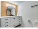 Modern bathroom featuring wood wall, white vanity, and chrome fixtures at 4671 S Decatur St # 232, Englewood, CO 80110