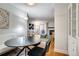 Open-concept dining area flowing into the living room with hardwood floors and plenty of natural light at 4671 S Decatur St # 232, Englewood, CO 80110