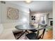 Dining area with a built-in bench, modern lighting, and views into the living room at 4671 S Decatur St # 232, Englewood, CO 80110