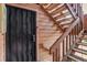 Exterior door with metal security and wooden staircase leading to upper level at 4671 S Decatur St # 232, Englewood, CO 80110