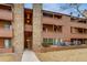 Three-story apartment building with brown wood paneling and outdoor staircases at 4671 S Decatur St # 232, Englewood, CO 80110