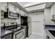 Modern kitchen with stainless steel appliances and sleek cabinetry at 4671 S Decatur St # 232, Englewood, CO 80110