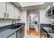 Well lit kitchen with stainless steel oven and hardwood floors flowing into the living room at 4671 S Decatur St # 232, Englewood, CO 80110