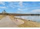 Peaceful view of lakeside park with winding sidewalk, and ample bench seating at 4671 S Decatur St # 232, Englewood, CO 80110