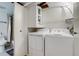 Convenient laundry area with modern washer and dryer units and overhead storage at 4671 S Decatur St # 232, Englewood, CO 80110