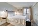 Bedroom with a bed, side tables, and natural light from the window at 4671 S Decatur St # 232, Englewood, CO 80110