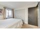 Cozy bedroom featuring a bed and natural lighting coming from the window at 4671 S Decatur St # 232, Englewood, CO 80110