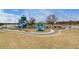 A playground with slides, various play equipment, covered tables, and nearby neighborhood at 4671 S Decatur St # 232, Englewood, CO 80110