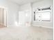 Spacious bedroom featuring neutral carpet, large windows, and ensuite bathroom access at 20968 E 60Th Pl, Aurora, CO 80019