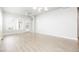 Bright, spacious living room features sleek hardwood floors, modern lighting, and large windows at 20968 E 60Th Pl, Aurora, CO 80019