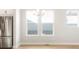 Bright dining area with a stainless steel refrigerator and plenty of natural light from large windows at 20968 E 60Th Pl, Aurora, CO 80019