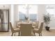 Cozy dining area featuring a round table with chairs, a rug, and natural light from the window at 20968 E 60Th Pl, Aurora, CO 80019