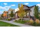 Street view showcasing well-maintained homes with manicured lawns and sidewalks at 20968 E 60Th Pl, Aurora, CO 80019