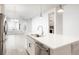 Modern kitchen island with a stainless steel sink and open floor plan at 20968 E 60Th Pl, Aurora, CO 80019