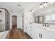 Bright bathroom with double vanity, a soaking tub and a large glass enclosed shower at 7016 E 126Th Pl, Thornton, CO 80602