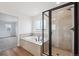 Modern bathroom featuring a tiled shower, separate soaking tub, and stylish fixtures at 7016 E 126Th Pl, Thornton, CO 80602