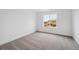 Bedroom with neutral carpet and a window looking at the neighboring home at 7016 E 126Th Pl, Thornton, CO 80602
