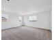 Bedroom featuring neutral carpet, modern trim, and two large windows at 7016 E 126Th Pl, Thornton, CO 80602