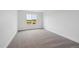 Bedroom with neutral carpet and a large window overlooking a neighboring home at 7016 E 126Th Pl, Thornton, CO 80602