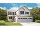 Charming two-story home featuring board and batten siding, a three-car garage, and a welcoming front porch at 7016 E 126Th Pl, Thornton, CO 80602