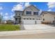 Inviting two-story home boasts a three-car garage, manicured lawn, and a charming covered porch at 7016 E 126Th Pl, Thornton, CO 80602